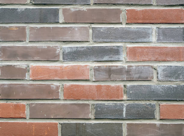 istock Texture of multicolored brick masonry. Background of wall pattern. Close-up 1308216859