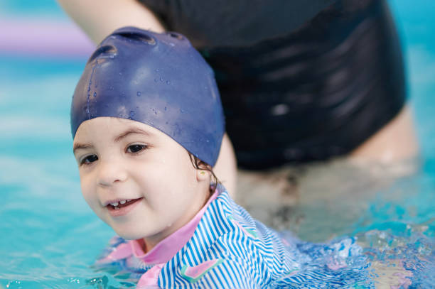 istock Kid swim in swimming pool 1308222969
