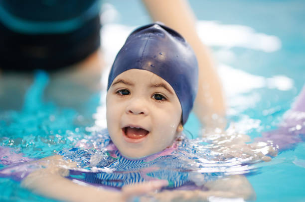 istock Swimming lessons for child in pool 1308222981