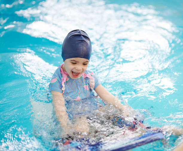 istock Happy girl on swimming lessons 1308223009
