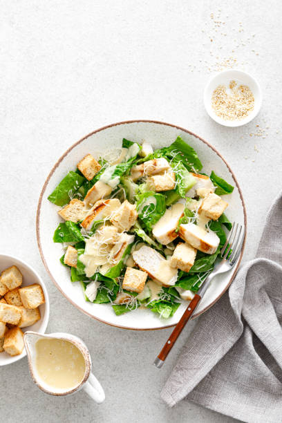 istock Caesar salad with parmesan cheese, grilled chicken meat and croutons 1308224576