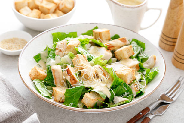 istock Caesar salad with parmesan cheese, grilled chicken meat and croutons 1308224765