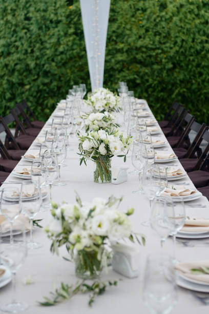 istock Table setting with sparkling wineglasses and cutlery in tent outdoors, copy space. Place setting at wedding reception. Table served for wedding banquet in restaurant 1308226176