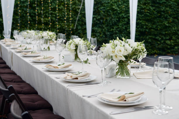 istock Table setting with sparkling wineglasses and cutlery in tent outdoors, copy space. Place setting at wedding reception. Table served for wedding banquet in restaurant 1308226178