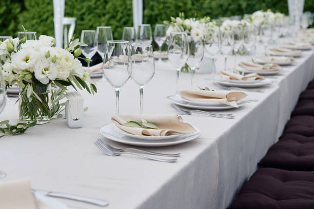 istock Table setting with sparkling wineglasses and cutlery in tent outdoors, copy space. Place setting at wedding reception. Table served for wedding banquet in restaurant 1308226180