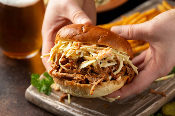 istock Homemade BBQ Pulled Pork burger with coleslaw, fries and beer 1308228331