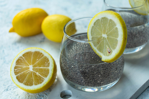 Water with chia seeds and lemon on  a white background. A useful drink for weight loss.