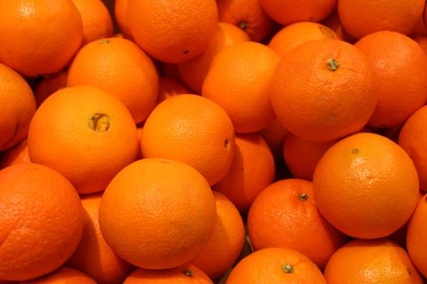 Navel Oranges Fresh, brightly-colored navel oranges on display in a supermarket navel orange photos stock pictures, royalty-free photos & images