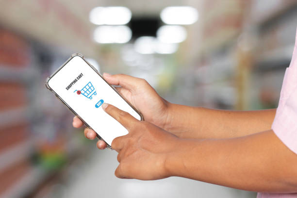 istock man using smartphone purchase in supermarket. online business service concept. 1308229844