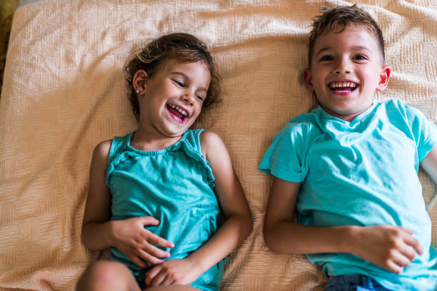 istock Beautiful children playing on the bed 1308230899