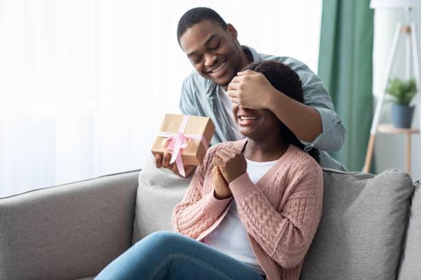 istock African american guy giving gift box to his girlfriend 1308230909