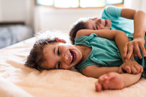 istock Beautiful children playing on the bed 1308231019