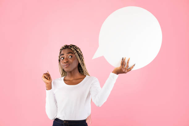 istock Pensive black woman hoding speech bubble at studio 1308231252