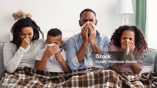 Sick Black Family Blowing Runny Noses With Napkins Together Stock Photo - Download Image Now