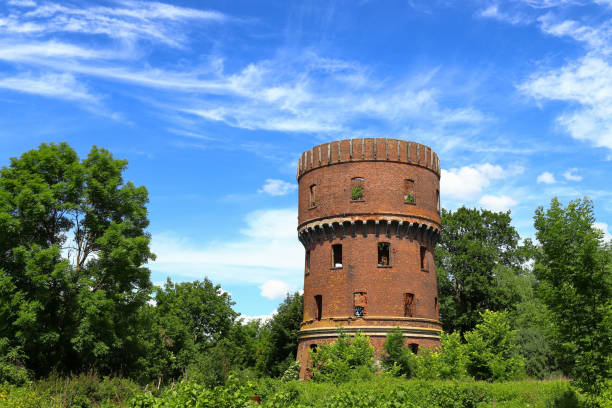 Abandoned red brick water tower with windows in the city of Sovetsk, Kaliningrad region