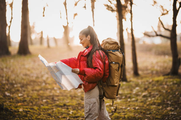 istock Hiker female looking at map for directions 1308232283