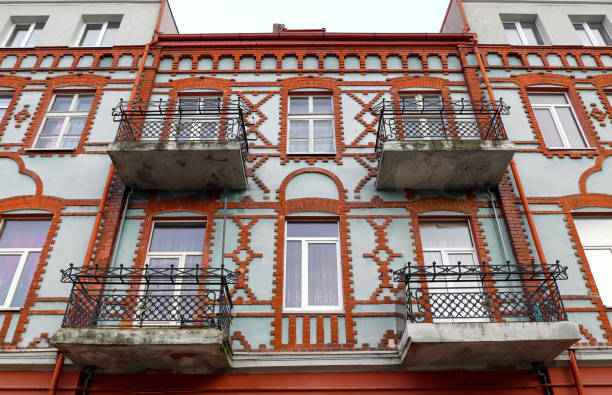istock Old brick house in German style with decorative wrought-iron balconies 1308232369