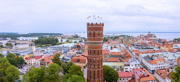 Kalmar cityscape, water tower close, Ölandsbron bridge in background