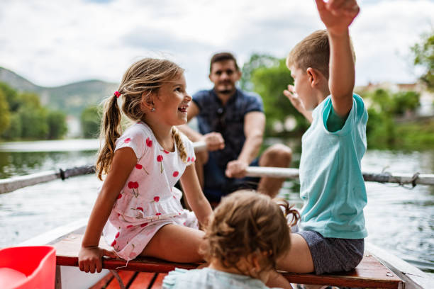 Beautiful young family sits in their ski boat ready to go skiing