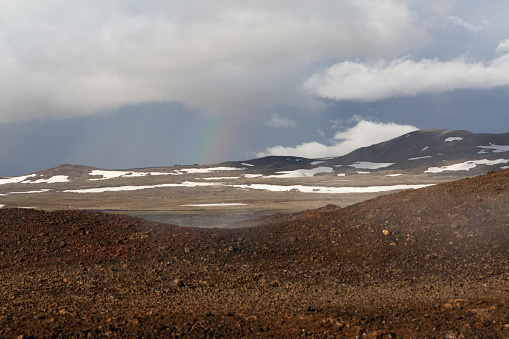 One women at the bottom of the Hverfjall volcanic crater.  Hverfjall, is one of the best preserved circular volcanic craters in the world and it is possible to walk around and inside it.