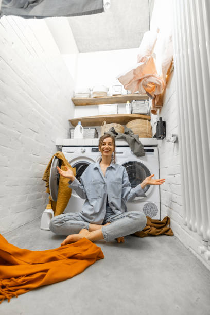 istock Woman throwing up clothes at the laundry 1308234667