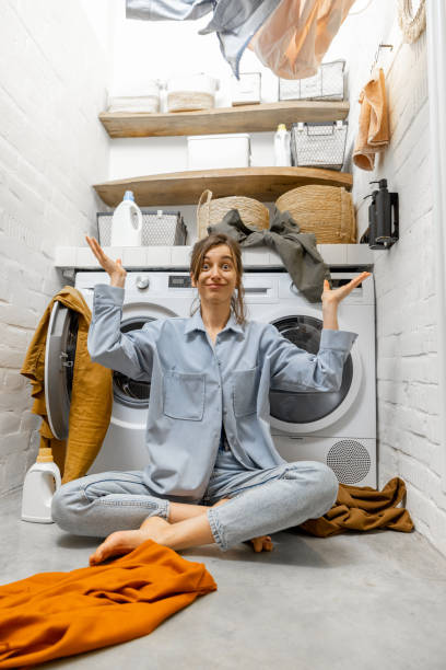 istock Woman throwing up clothes at the laundry 1308234690
