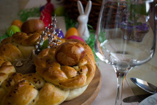 Close up of Easter table decoration. Traditionally homemade braided bread and natural dyed eggs with onion skins