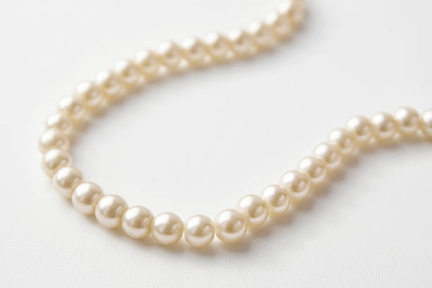 istock Pearl necklace on white background, close-up 1308236150
