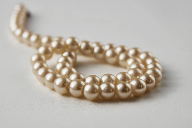 istock Pearl necklace on white background, close-up 1308236152