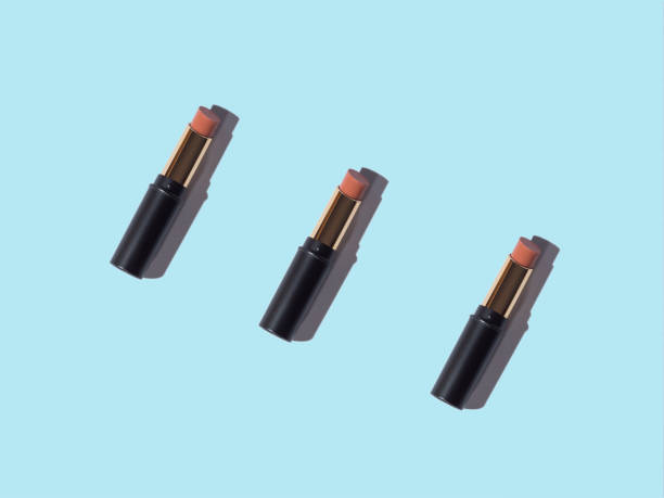 istock Nude lipstick make up beauty minimal pattern on blue background 1308237002