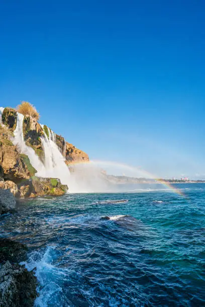 The scenic view of Düden waterfall and rainbow on a sunny day from different sea levels in Antalya