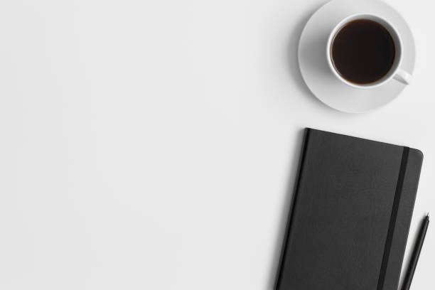 istock Workspace accessories  and a cup of a coffee on a white table.  Flat lay with blank copy space. 1308237351
