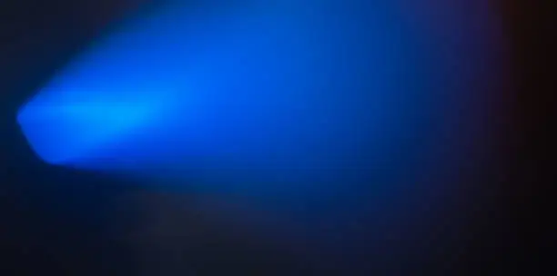 Photo of Blue light beam on a dark background