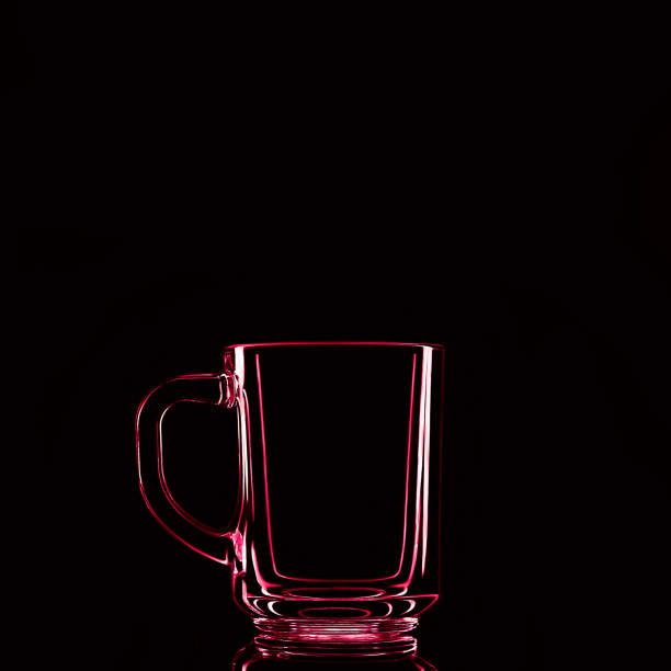 istock Just a glass on a black background with a reflection. Red colors. 1308239261