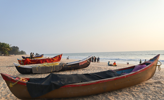 A Dramatic Twilight picture of the Padubidri, one of the Blue Flag Beach destinations in the world seen with the Fishing boats Stationed on the Sands near Mangalore city in Karnataka, India.