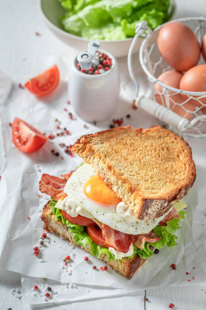 istock Homemade sandwich with bacon, egg and mayonnaise. British breakfast. 1308240333