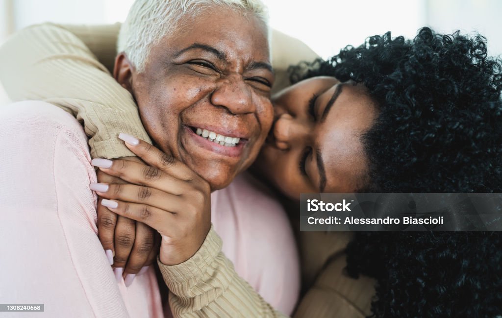 Happy Hispanic mother and daughter having tender moment together - Parents love and unity concept Mother Stock Photo