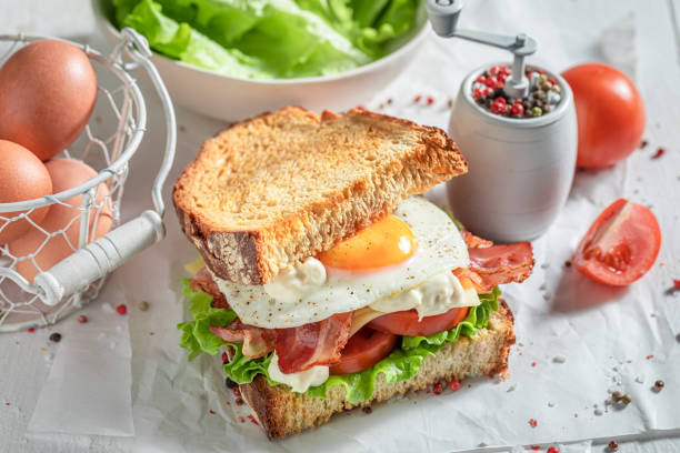 istock Crunchy sandwich with egg, vegetables and bacon. British breakfast. 1308240843