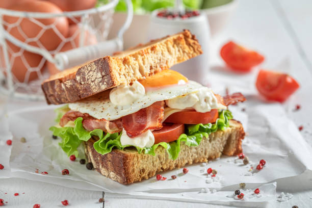 istock Tasty sandwich with egg, bacon and tomato. British breakfast. 1308241427