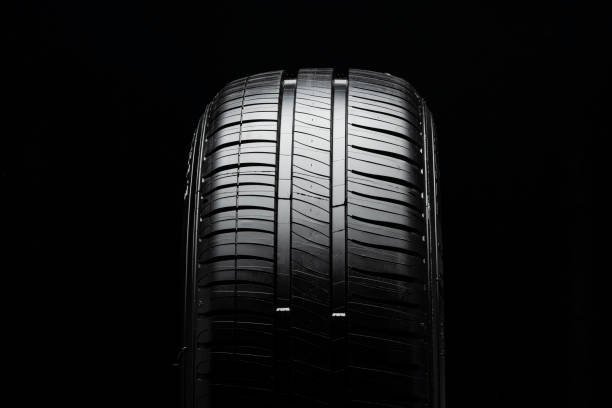 istock modern summer tire with two drainage channels on a black background, front view, 1308241519