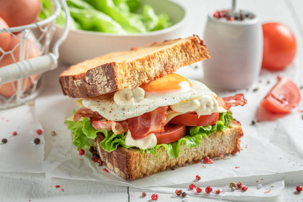 istock Crunchy sandwich with egg, bacon and tomato. British breakfast. 1308241520