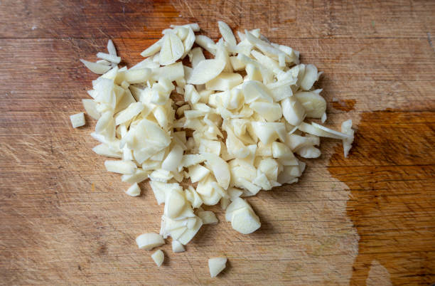 istock Garlic cloves on a wooden board 1308241558