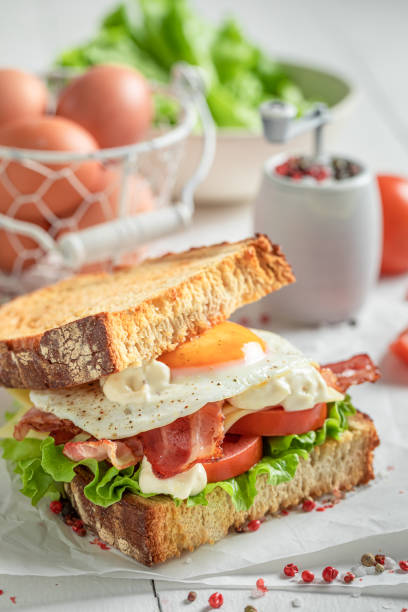 istock Crunchy sandwich with bacon, egg and mayonnaise. British breakfast. 1308241705