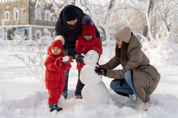istock Happy mom dad and two daughters winter sunny day 1308243923