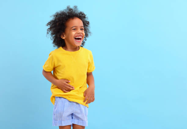 istock Positive African American little boy laughing in blue studio 1308245071