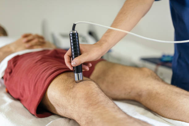 istock Physiotherapist applying electro stimulation to legs in physical therapy 1308245112