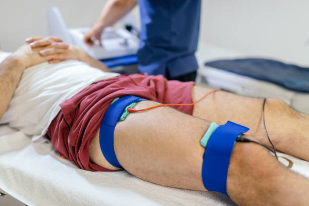 istock Physiotherapist applying electro stimulation to legs in physical therapy 1308245295
