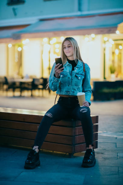 istock Woman using smartphone in the city 1308246435