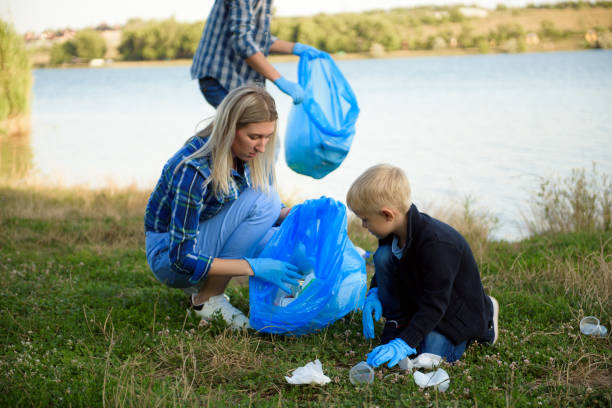 istock volunteering, charity, people and ecology concept, volunteers using garbage bag while collecting litter 1308247500