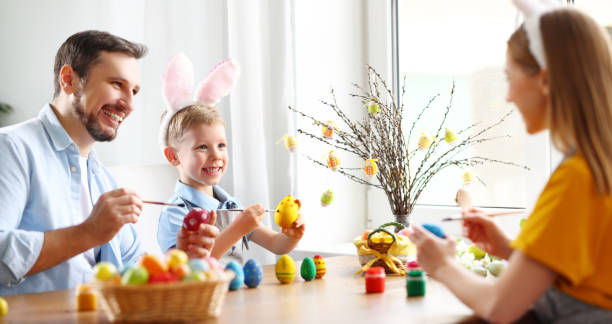 istock Happy family painting Easter eggs together 1308247621